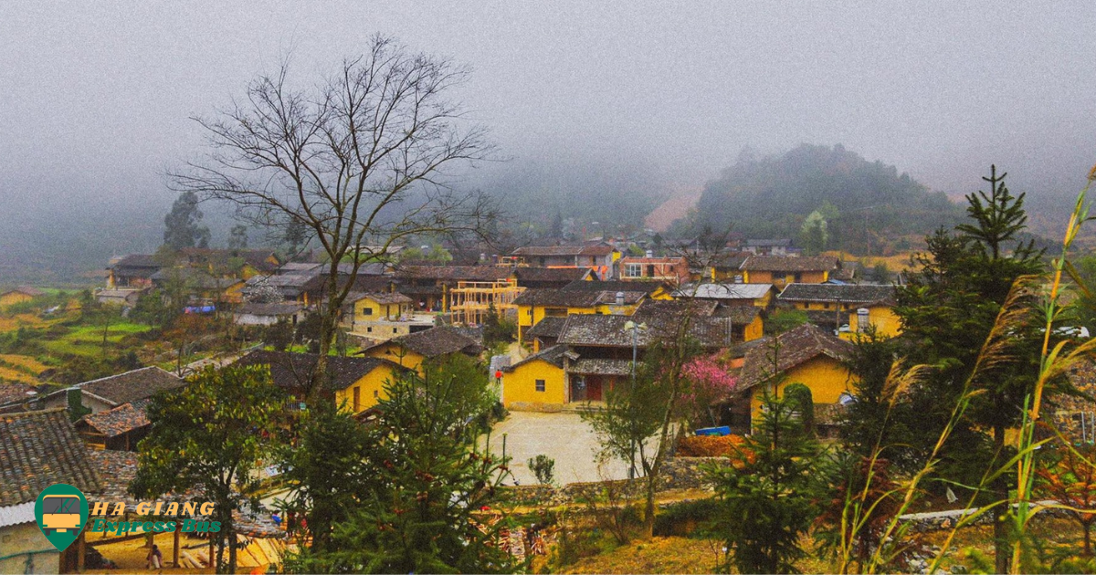 A serene scene of Lo Lo Chai village surrounded by green mountains, with traditional stilt houses and winding paths