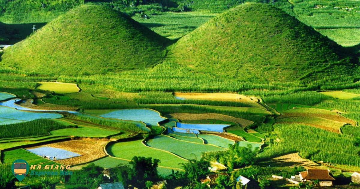 A panoramic view of the iconic Quan Ba Twin Mountains, surrounded by lush greenery